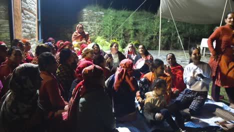 Nepali-woman-joyfully-clapping-and-playing-drums-at-night