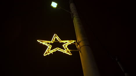 Tilt-down-shot-of-christmas-decorated-street-at-Kifissia,-Greece-4K