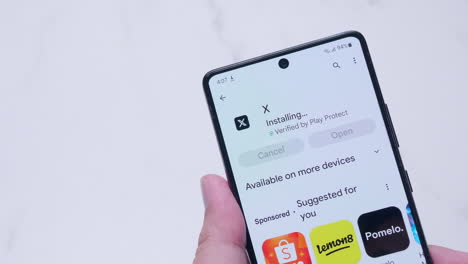 Close-up-of-an-individual-downloading-and-insatlling-some-applications-from-an-online-app-store-using-a-smart-phone