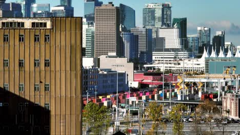 A-Scene-Featuring-Vehicles-Moving-Along-the-Skyway-with-Buildings-in-the-Backdrop-in-Centerm---Major-Container-Port-in-Vancouver,-British-Columbia,-Canada---Pan-Up-Shot