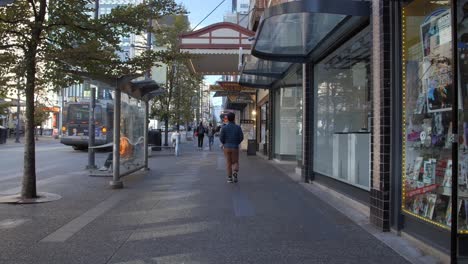 Vancouver,-Canada---People-Strolling-Past-Commercial-Establishments-in-the-Urban-Area---Tracking-Shot