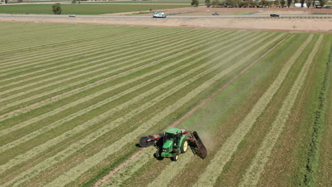 Aerial-shot-of-tractor-pulling-harrows-in-Imperial,-California