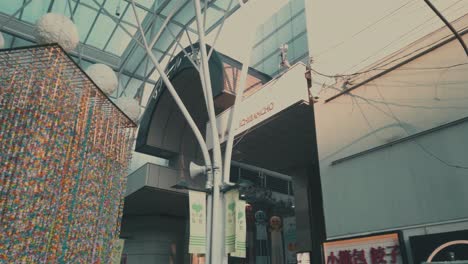 People-in-arcade-walking-through-decorative-paper-streamers-during-Tanabata-festival