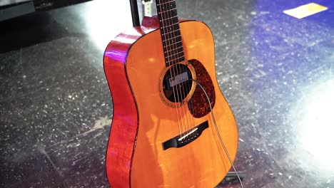 A-close-up-look-of-a-guitar-on-stage-ready-to-be-played-for-a-concert