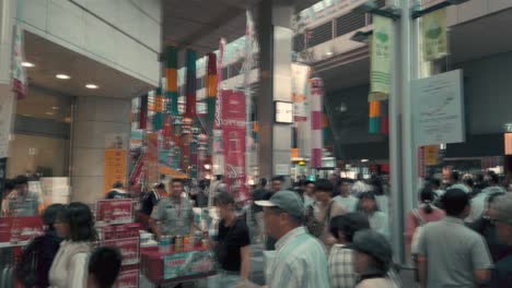 People-on-busy-street-walking-through-decorative-paper-streamers-during-Tanabata-festival-in-slow-motion