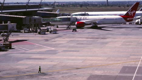 Airport-ground-staff-waiting-for-airplanes-parked-at-gate