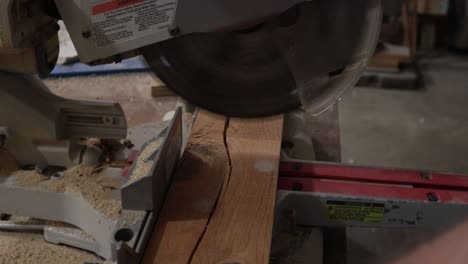 Man-cutting-wood-with-table-saw