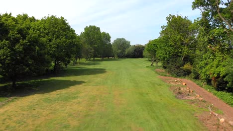 Aerial-Golf-Flyover-with-Bunker,-Pond-and-Putting-Green