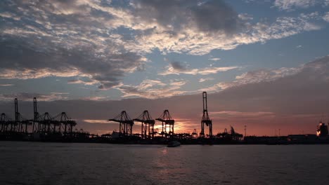 Container-crane-at-Bukom-Island-on-the-sunset-background-behind,-taken-from-Labrador-Jetty