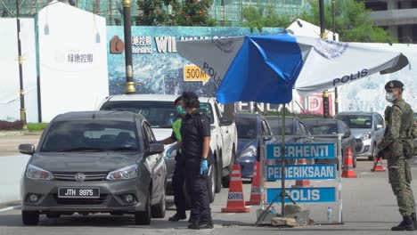 Police-Officers-in-Malaysia-Checking-Documents-at-a-Checkpoint