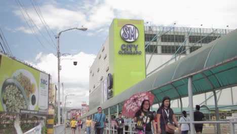 View-of-SM-Mall-with-pedestrians-walking-in-the-background,-Olongapo-city-Philippines