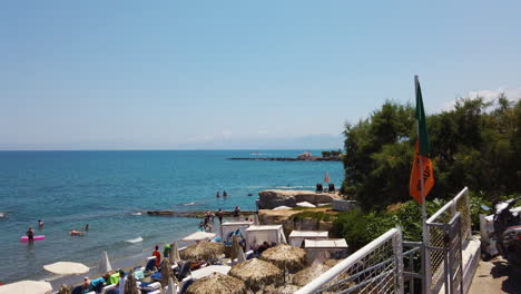 Secluded-beach-with-blue-sea-in-Crete,-Greece,-with-a-small-crowd