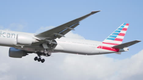 El-Avión-De-American-Airlines-Llega-Para-Aterrizar-En-El-Aeropuerto-De-Heathrow-En-Londres-En-Un-Día-Soleado,-Algunas-Nubes