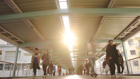 People-Walking-Through-Elevated-Walkways-Connecting-Buildings-In-Hong-Kong---Low-Level-Shot