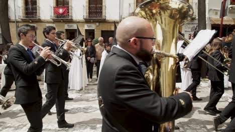 Semana-Santa-–-Die-Kamera-Neigt-Sich-Nach-Oben-Und-Zeigt-Eine-Blaskapelle,-Die-Zur-Feier-Der-Karwoche-Durch-Die-Straßen-Spaniens-Marschiert