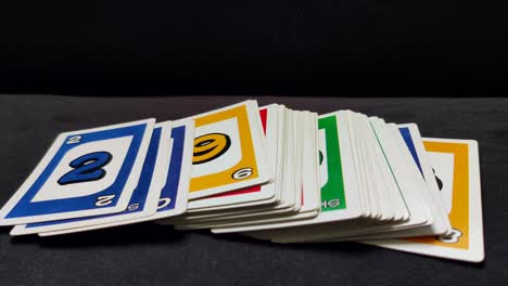 Close-up-shot-of-a-male-hand-laying-out-a-deck-of-Uno-playing-cards