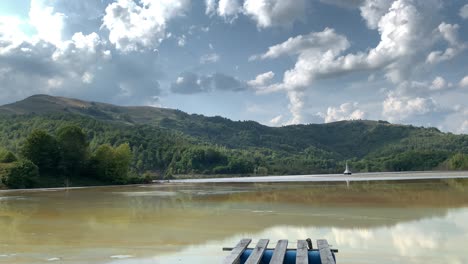 Panoramic-shot-of-a-lake-in-Rosia-Montana,-Geamana,-with-the-old-sunken-church-in-the-midle-of-it