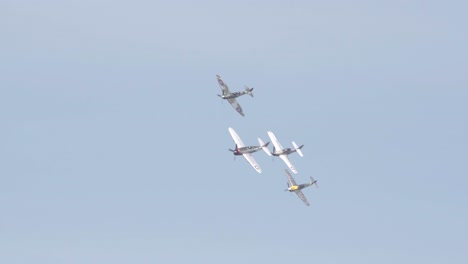 P-fifty-one-Mustang,-Spitfire,-Japanese-Zero,-and-Messerschmitt-Bf-Banking-While-Flying-in-Unison