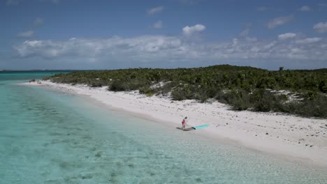 Lone-Tourist-Social-Distancing-on-White-Sand-Beach-in-Bahamas,-Aerial