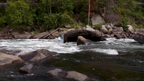 Group-of-white-water-rafters-paddles-down-the-Gauley-River-in-Fayetteville,-WV