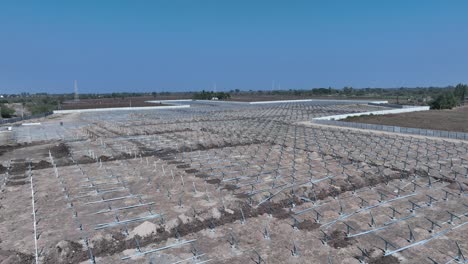 Aerial-view-of-large-sustainable-electrical-power-plant-with-rows-of-solar-photovoltaic-panels-for-producing-clean-electric-energy