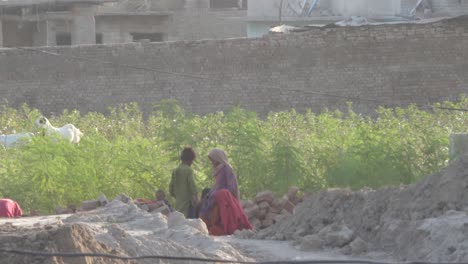 Close-up-shot-of-a-family-displaced-and-living-outdoors-after-their-houses-damaged-due-to-severe-floods-in-Sindh,-Pakistan-at-daytime