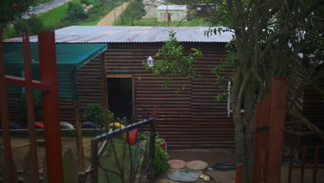 Wooden-cottage-within-greenery-and-playground