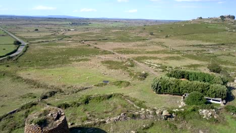 Sardinia,-Drone-Aerial-shot-towards-a-Nuraghe-a-monolith-prehistorical-construction-in-the-island-of-Sardinia-in-Italy