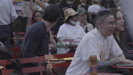 People,-handsome-man,-laughing-woman,-cute-crowd-enjoying-and-jamming-to-a-performance-or-music-venue-outdoors-in-New-York-City,-NYC