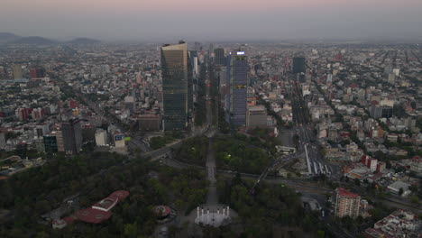 Aerial-view-capital-Mexico-city-modern-cityscape-panorama-with-high-buildings,-vehicles-in-city-roads-traffic