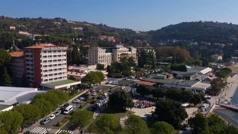 Forward-flying-drone-aerial-close-up-view-of-Trieste-hotel-area,-Italy