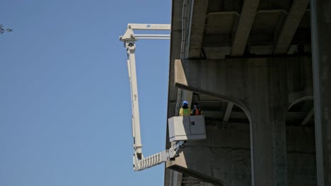 Inspección-Debajo-Del-Puente-Del-Puente-Cortado-Por-Nieve-En-Carolina-Beach,-Carolina-Del-Norte,-Usando-Un-Camión-Grúa-Debajo-Del-Puente-Con-Brazo-Hidráulico-Telescópico