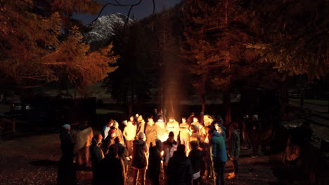 Time-lapse-shot-showing-group-of-people-enjoying-gigantic-campfire-outdoors-in-Austria