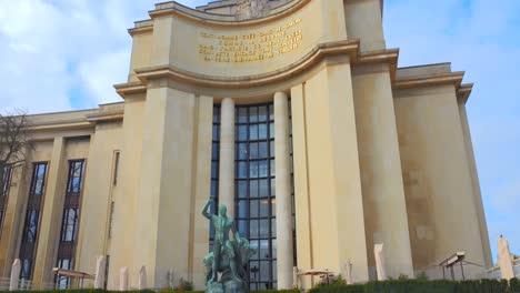 Tilt-up-shot-of-bronze-statue-of-Hercules-and-the-buffalo-bull-in-front-of-Trocadero-left-wing-in-Paris,-France-at-daytime