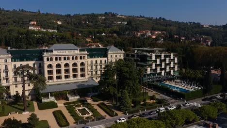 Forward-flying-drone-aerial-view-of-Trieste-Kempinski-palace-hotel,-Italy