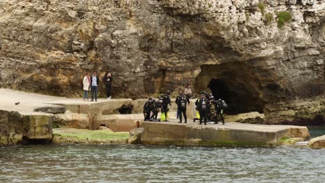 Group-Of-Divers-Preparing-For-Diving-In-The-Anchor-Bay,-Shot-From-The-Popeye-Village