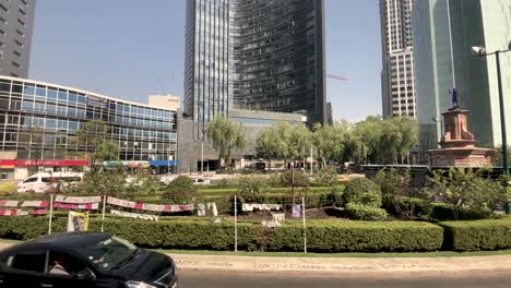 slow-motion-shot-of-roundabout-paseo-de-la-reforma-avenue-with-the-passage-of-the-metrobus