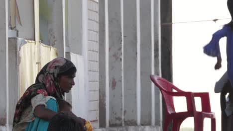 Close-up-shot-of-displaced-family-living-in-a-government-building-due-to-damaged-houses-after-severe-flooding-in-Sindh,-Pakistan-at-daytime