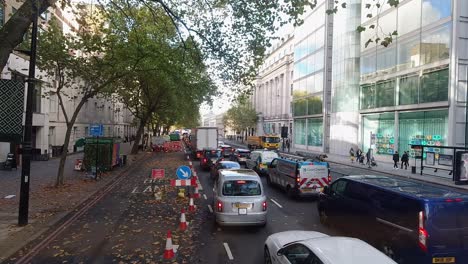 Timelapse-from-London-Bus-front-seat-of-people,-buses-and-traffic-with-sight-of-warren-street-and-euston-station