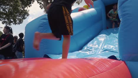 A-slow-motion-shot-of-a-child-climbing-up-a-bouncy-castle-in-full-hd-30fps