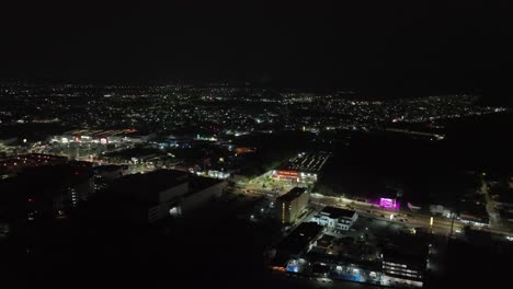 Aerial-View-Of-Cars-Driving-In-The-Streets-Of-Manzanillo-City-At-Night-In-Colima,-Mexico