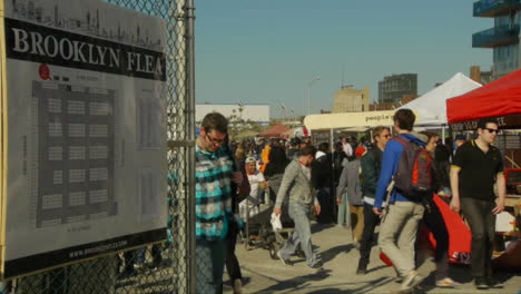 Shoppers-leaving-Brooklyn-Flea-Market-entrance-as-stall-holders-start-to-pack-up-for-the-day