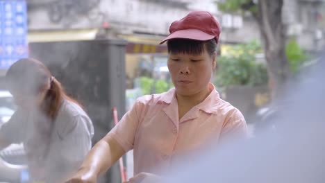 Chinese-Female-Cook-in-Authentic-Open-Restaurant-in-Guangzhou,-China,-Close-Up