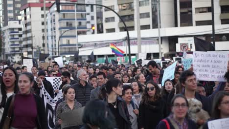 In-Quito,-Ecuador,-women-and-men-are-peacefully-protesting,-marching-and-chanting-songs-against-inequality,-marches-in-favor-of-women-rights-with-messages-written-on-boards