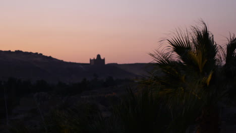 The-Aga-Kahn-Mausoleum-at-sunset-seen-across-the-Nile-River-in-Aswan,-Egypt