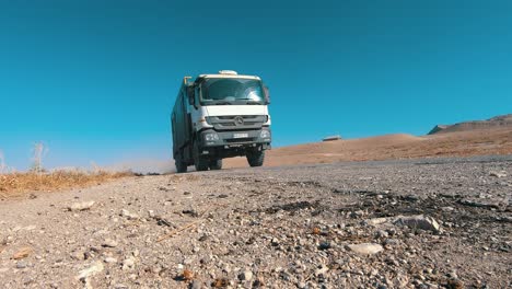 Industrial-truck-driving-by-under-wheel-shot