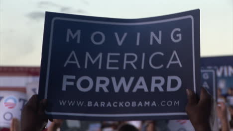 Close-up-of-a-Moving-America-Forward-poster-being-held-up-by-a-Democrat-supporter-in-a-large-crowd-at-a-Presidential-rally-at-Orr-Middle-School-in-Las-Vegas