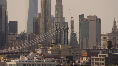 Toma-Amplia-Del-Puente-De-Manhattan,-El-One-World-Trade-Center-Y-El-Edificio-Verizon-En-Nueva-York-Al-Atardecer