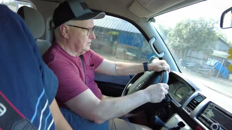 A-white-american-wearing-a-hat-while-driving-a-commuter-van