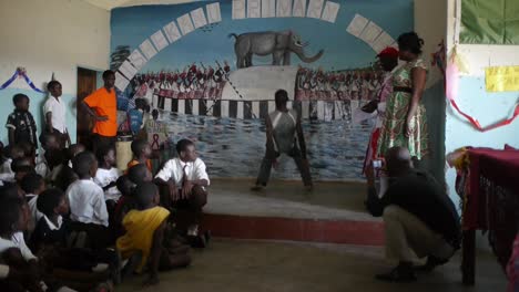 With-impressive-athleticism-and-dedication,-a-young-African-boy-demonstrates-his-ability-to-perform-frog-like-jumps-on-stage